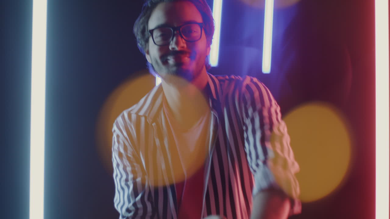 Man in Stylish Striped Shirt with Neon Lights