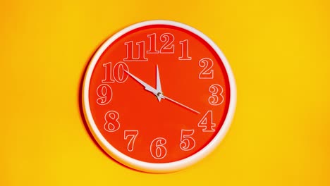 modern orange clock face beginning of time 11.43 on yellow background, time lapse 45 minutes moving fast.