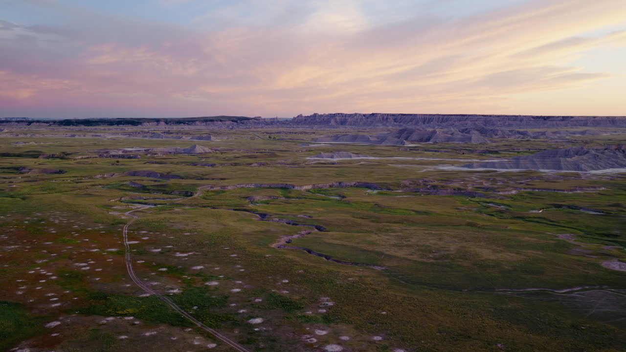 Wide Drone Views of Stark Badlands Formations at Sunset
