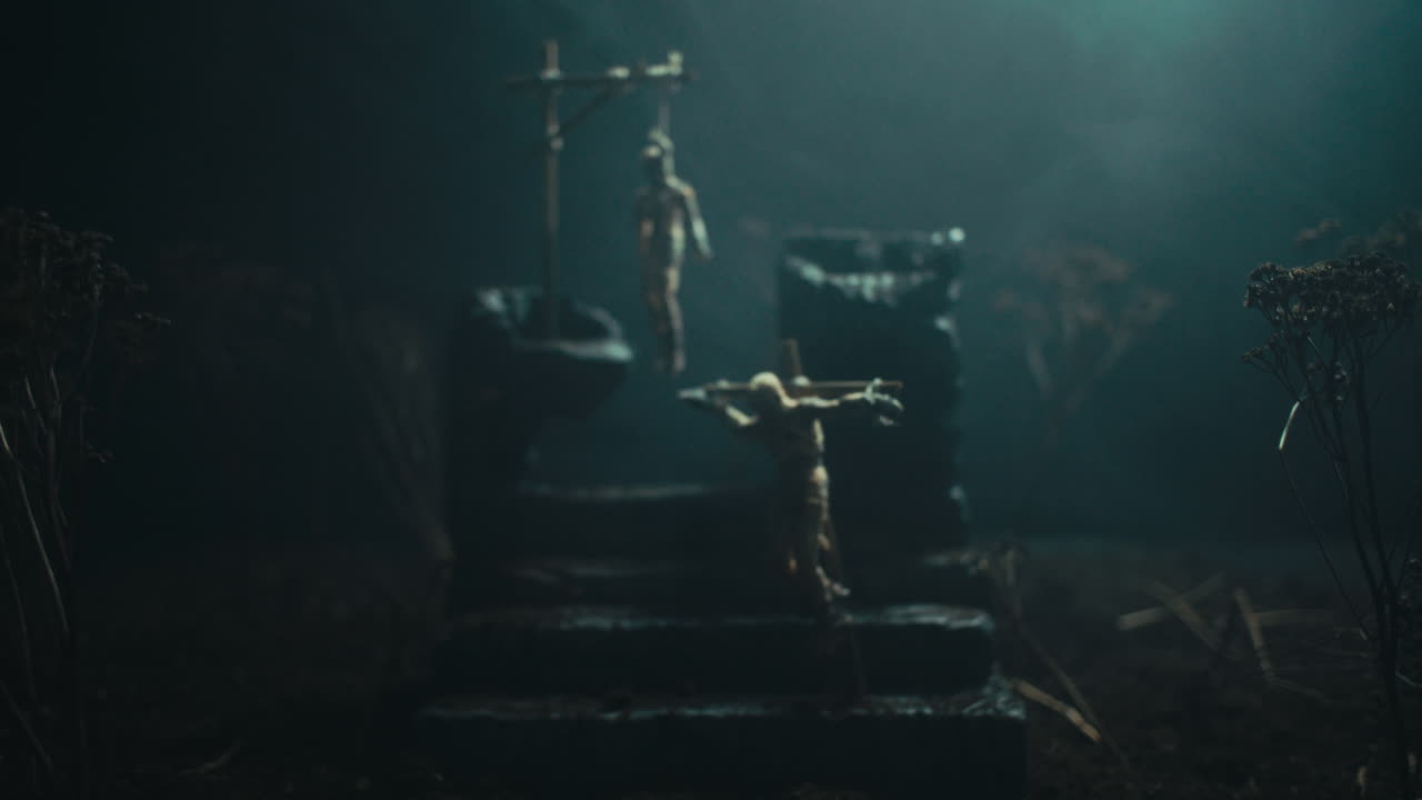 A miniature scene of the mummified dolls hanging on the gallows at night