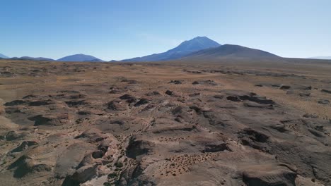 Aerial-pan-right-of-desert-landscape-in-Eduardo-Avaroa-National-Reserve,-Bolivia