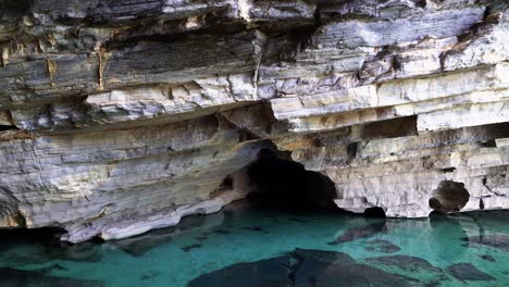 tilting down shot revealing a stunning grey cave