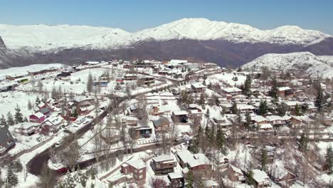 Aerial-view-circling-snow-covered-Farellones-village-neighbourhood-Santiago,-Chile-winter-mountain-landscape