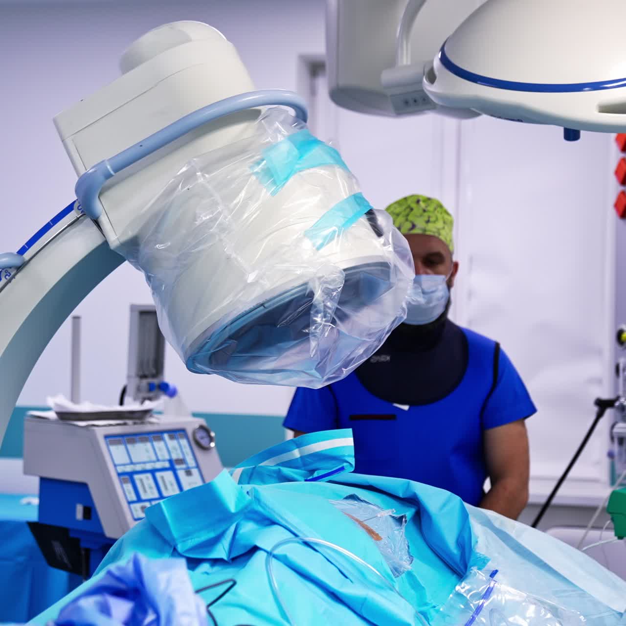 Special surgical equipment placed over the patient on the operational table. Male doctor standing behind the patient. Modern surgery backdrop