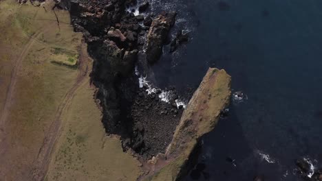 steep cliffs at shore of iceland shaped by years of sea erosion, aerial