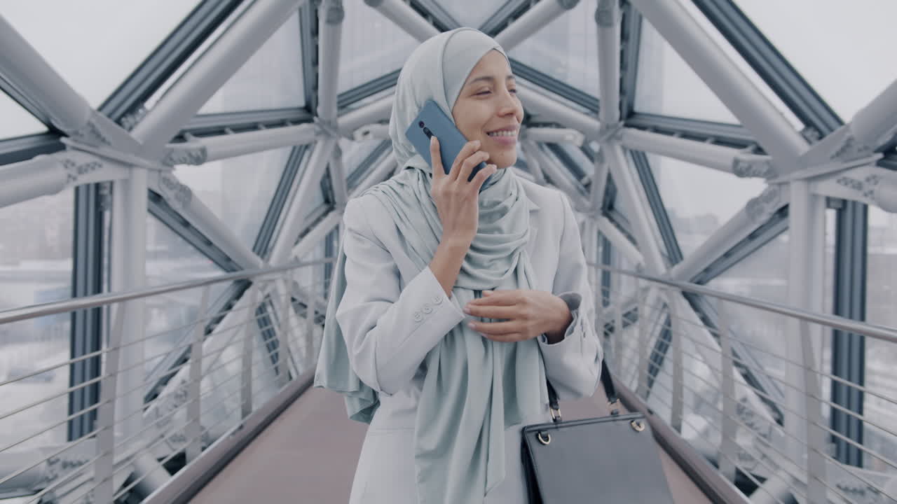 Businesswoman Talking on Phone on City Bridge