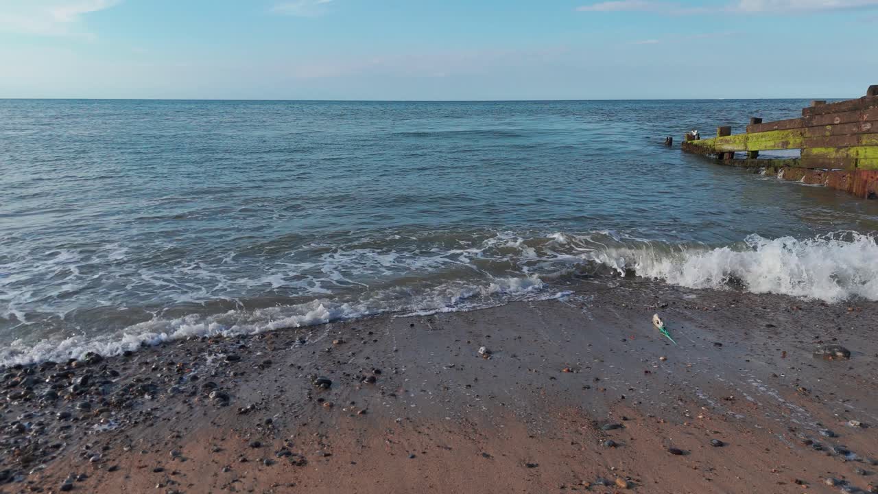 Rocky and sand pebble stones Sheringham beach ocean waves nature Norfolk England