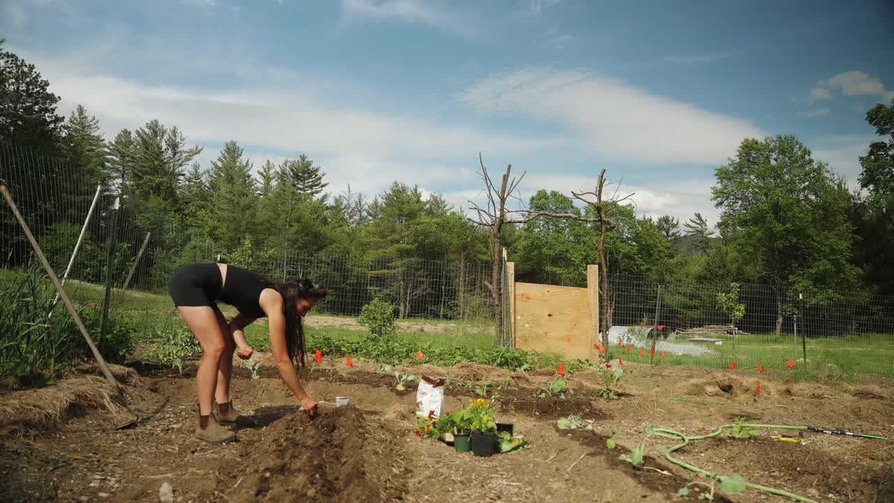 niña trabajando en el jardín en la granja rural homesteading