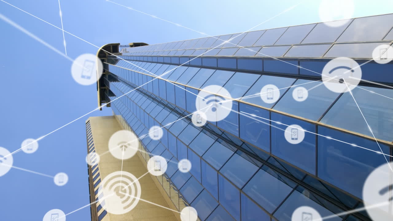 Animation of icons connected with lines over low angle view of glass building against sky
