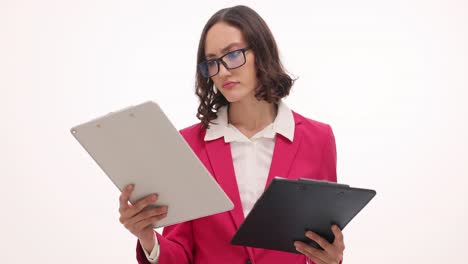 professional woman comparing documents on clipboards