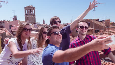 friends taking selfie on rooftop in venice