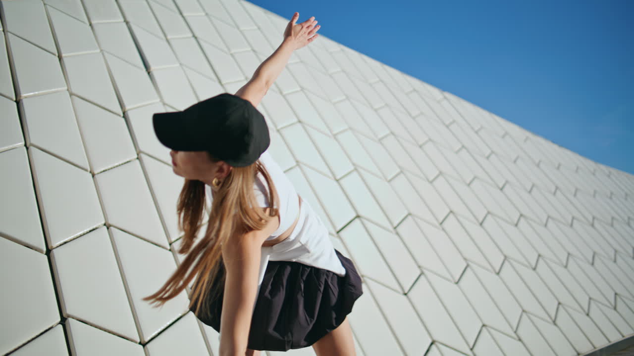 Fitness girl exercising sunny street near geometric wall closeup. Sport lady