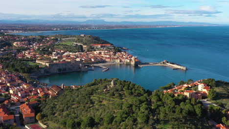 old windmill in collioure aerial view of the city france green trees and blue