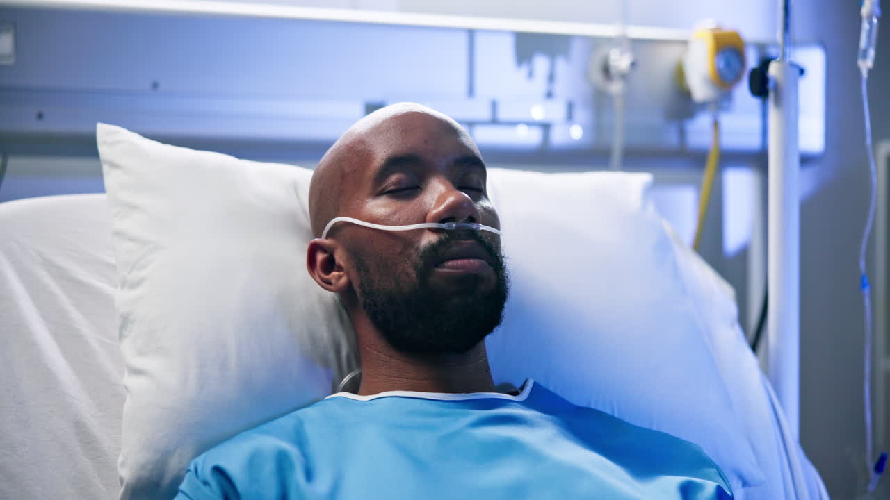 Man in Hospital Bed Receiving Oxygen