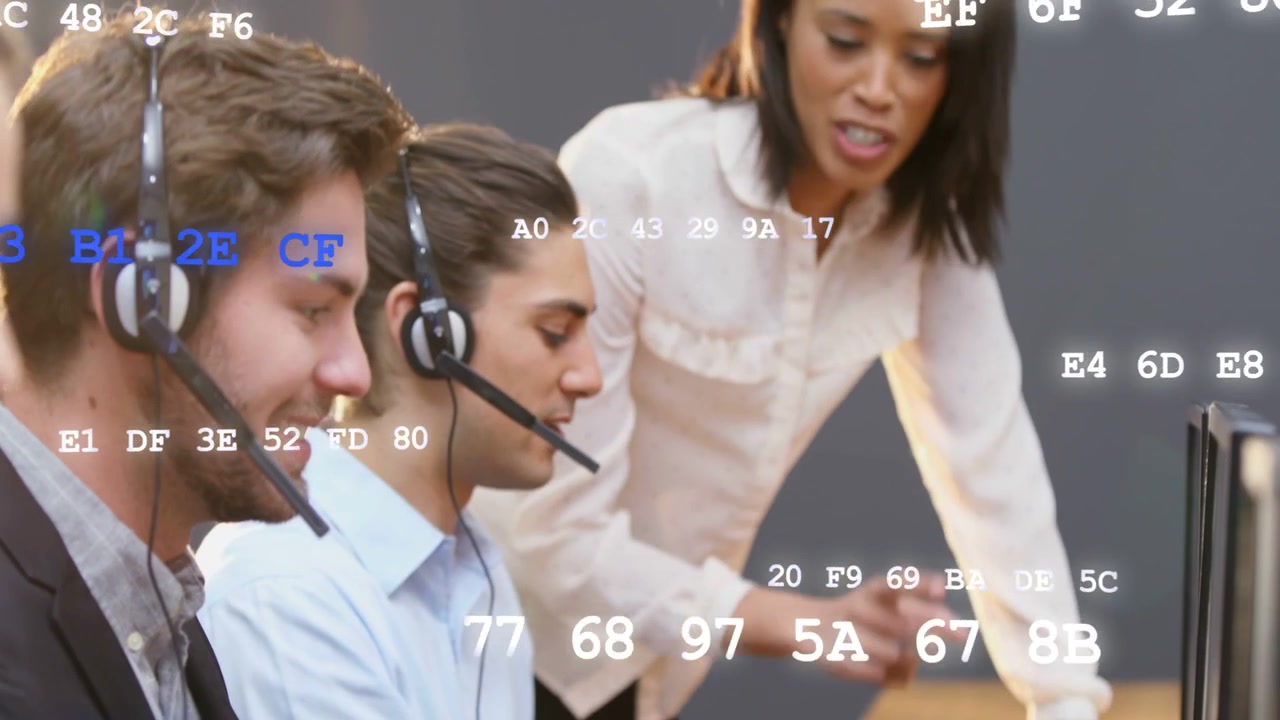 Woman supervisor approaching desk guiding team typing with hex data overlay for tech training