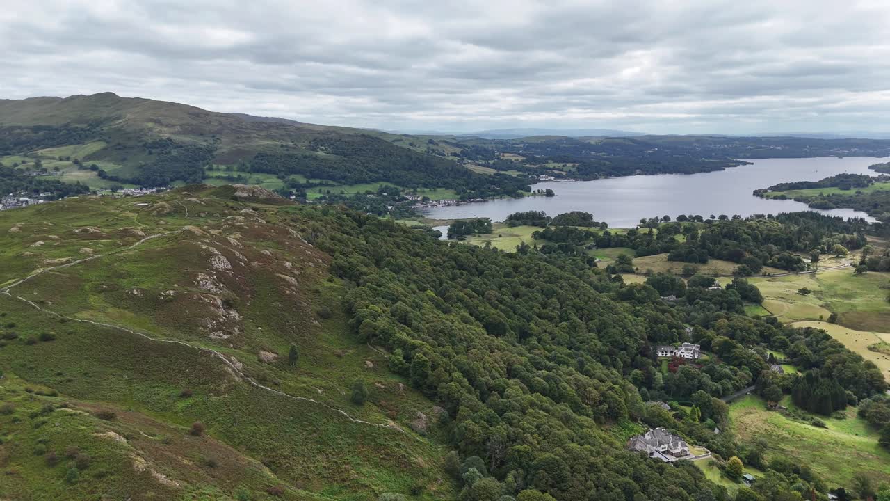 Aerial drone footage capturing sweeping views over Loughrigg Fell in the Lake District on a clear summer’s day