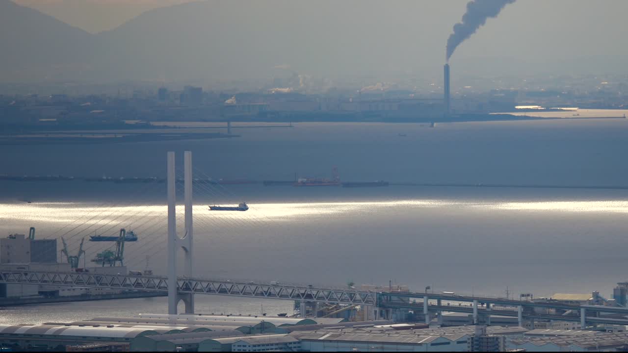 City skyline view by the sea with industrial chimney and modern bridge