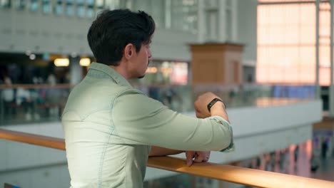 traveler man in 40s looking at the watch on his hand checking time at seoul train station hall - close-up, slow motion