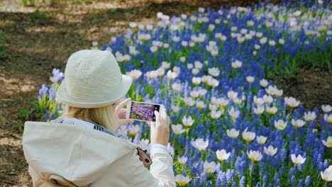 Young-Woman-Takes-Pictures-of-Spring-Flowers