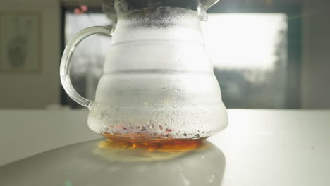 glass coffee jug with freshly brewed coffee in morning light