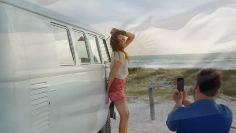 animation of waving flag of argentina over couple having fun on the beach