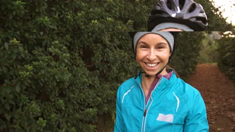 Portrait-of-female-mountain-biker-with-bike