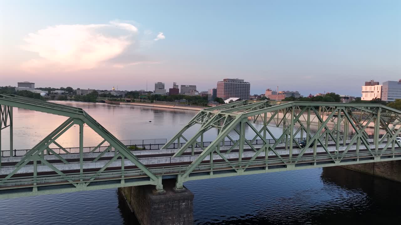 Suspension bridge between New Jersey and Pennsylvania st sunset. Skyline and downtown in background. Delaware River in America. Aerial wide shot
