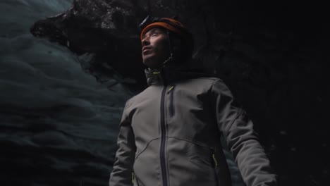 man standing in an ice cave formation in the vatnajökull glacier in iceland