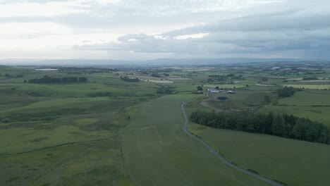 Morning-flyover-of-hazy-green-rural-landscape-of-Whitelee,-Scotland