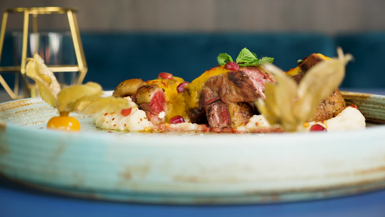 Gourmet Dish with Meat, Physalis, and Pomegranate