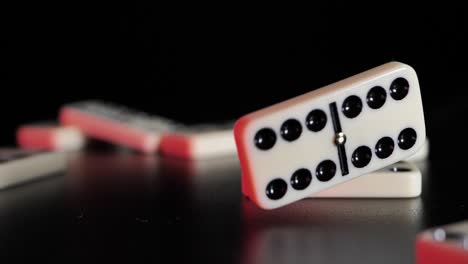 White-domino-dice-fall-on-a-black-background