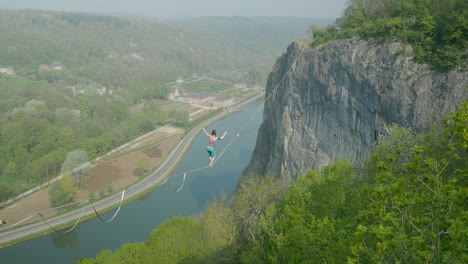 cinematic amazing woman slack line high line tight rope walking in mountains