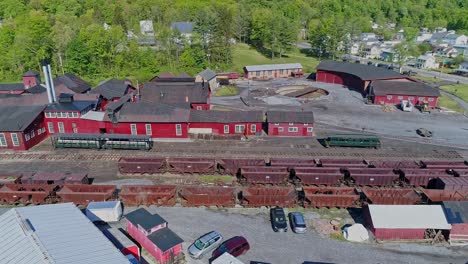 An-Aerial-View-of-an-Abandoned-Narrow-Gauge-Coal-Rail-Road-with-Rusting-Hoppers-and-Freight-Cars-and-Support-Building-Starting-to-be-Restored