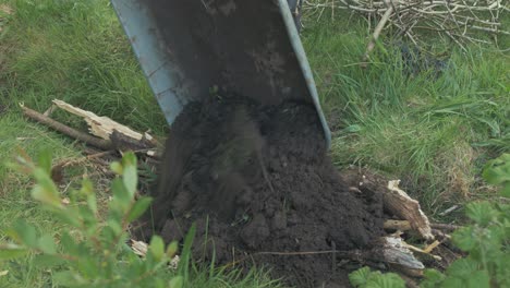 creating garden bed emptying soil over sticks hugelkultur technique