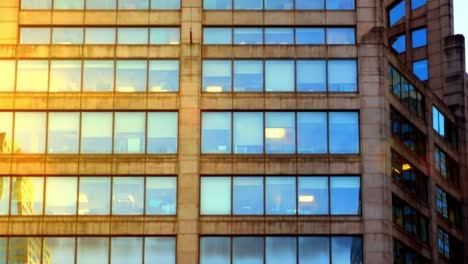 a stunning transformation of urban architecture captured from daylight to dusk, showcasing the intricate details of a modern office building's facade.
