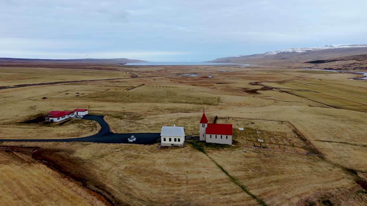 Aerial view of a small remote church in Iceland surrounded by dramatic landscapes. Minimalist architecture meets raw Nordic nature