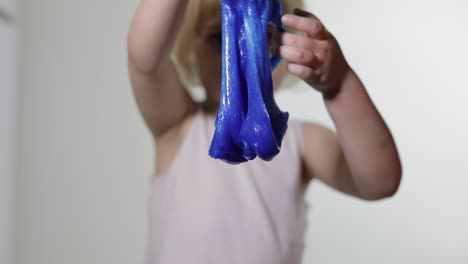 Child-having-fun-making-slime.-Kid-playing-with-hand-made-toy-slime.