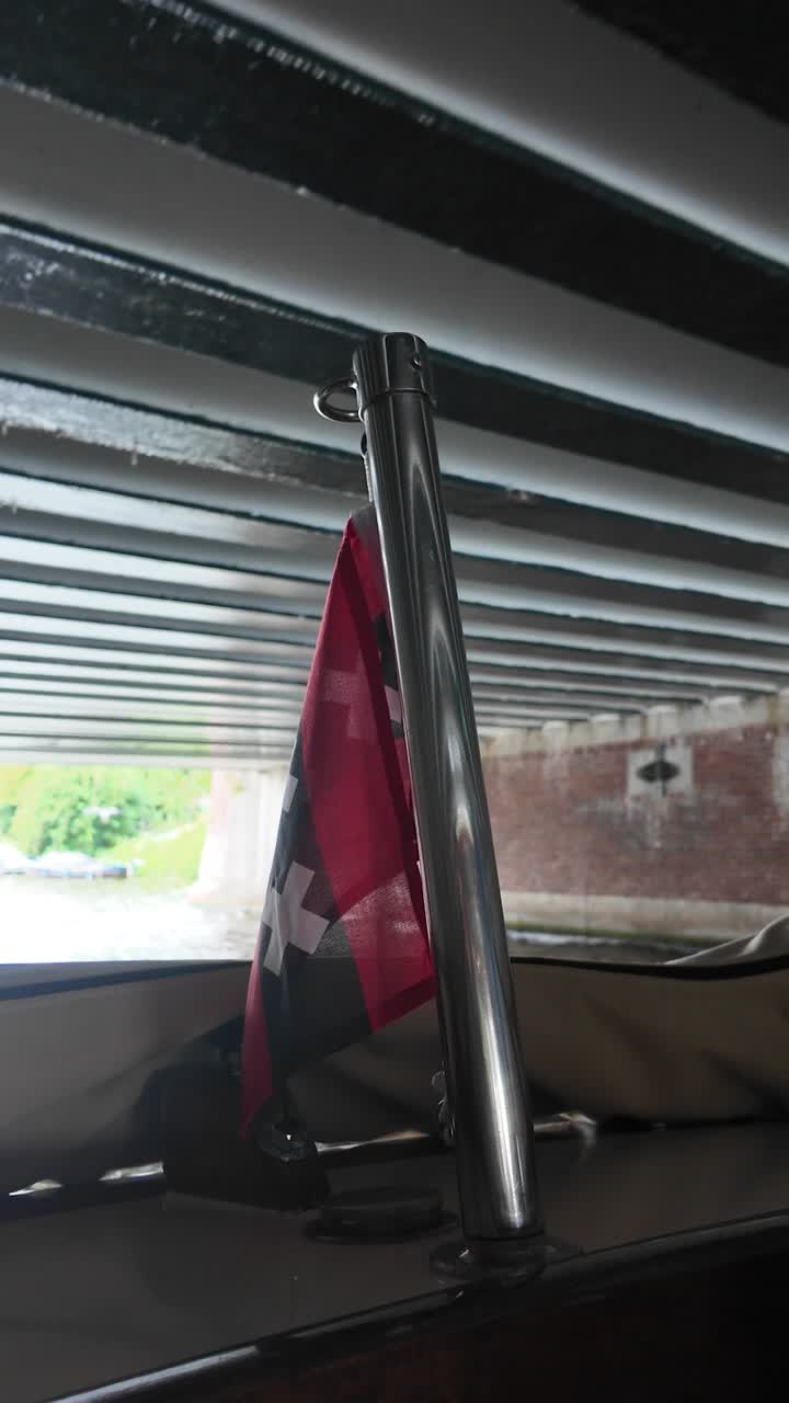 Flag out behind the boat on the river, Amsterdam, Netherlands, Europe