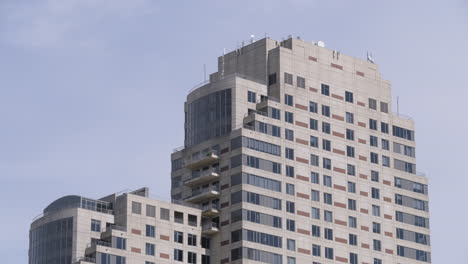 telephoto shot of the top of a tall building in the downtown of a large city