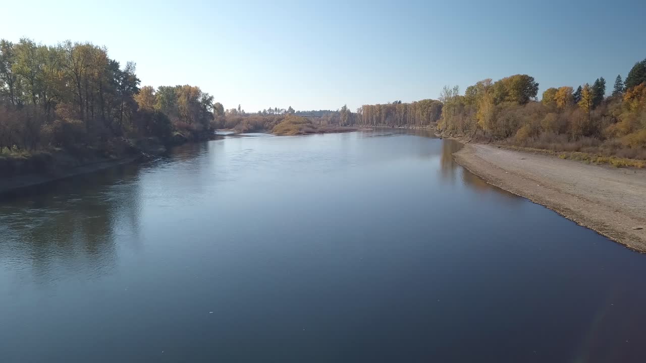 aerial footage of the willamette river south of Portland Oregon and the surrounding farm land. low flying drone over willammette river.
