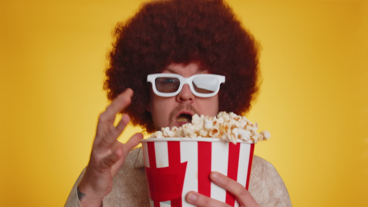 hombre emocionado comiendo palomitas de maíz y viendo interesantes series de televisión, juegos deportivos en línea películas de redes sociales