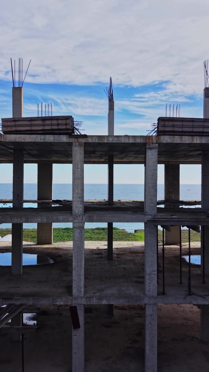 Observation of abandoned structure near water with sky in background
