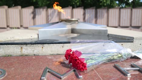 memorial with eternal flame and flowers