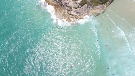 Sonniger-Himmel-über-Dem-Blauen-Ozean-Mit-Touristenschwimmen-Auf-Den-Tosenden-Meereswellen-Des-Zylinderstrandes-In-Queensland,-Australien