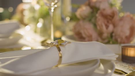 close up of napkin in ring on table set for meal at wedding reception in restaurant 5