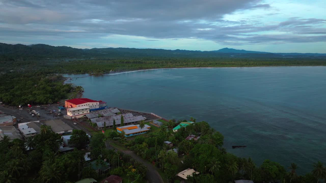 Early morning Sundaun Market Boram Rd Wewak Hill Cape Wom peninsula morning summer dry season Wewak costal town aerial drone Papua New Guinea PNG Dogreto Bay panoramic ocean view forward pan up motion