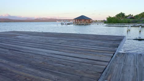 Low-angle-drone-flight-over-wooden-jetty