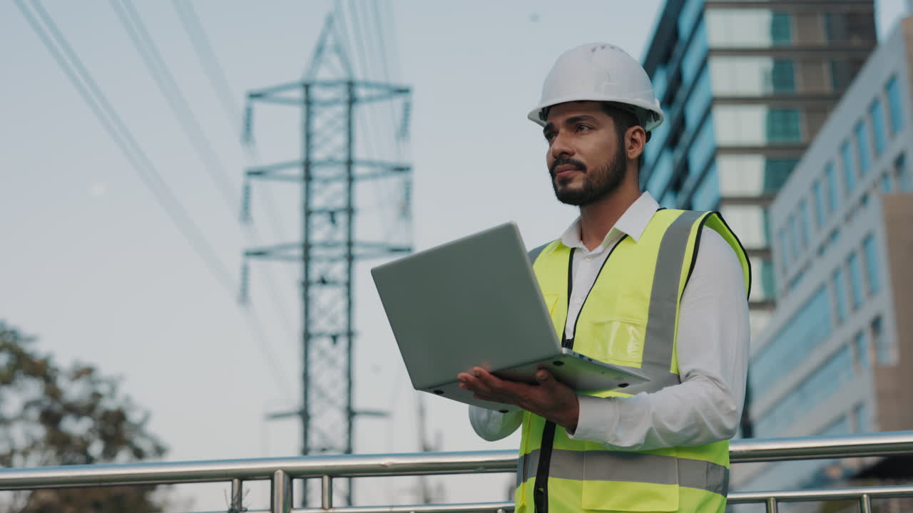 Engineer working outdoors with laptop