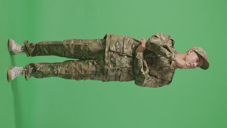 full body of asian man soldier thinking and looking around then raising his index finger while standing in the green screen background studio