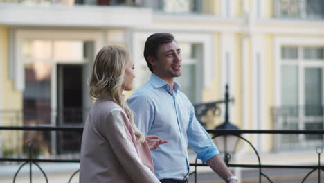 smiling business couple walking at street. business partners talking outside